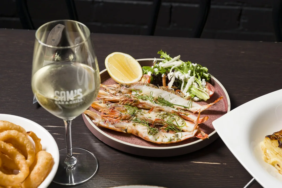 Prawns and a glass of wine at Sam’s Steakhouse
